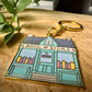 Porte-clés en métal émaillé de librairie