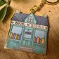 Porte-clés en métal émaillé de librairie